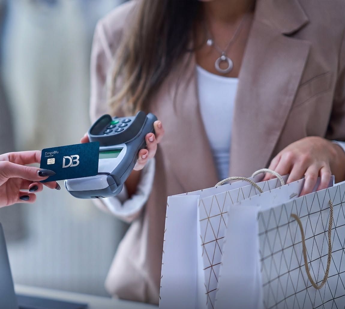 myDingoBlu card handed over at a store checkout with shopping bags